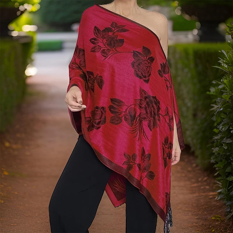 Femme portant le poncho écharpe framboise à roses, drapé asymétrique sur une épaule